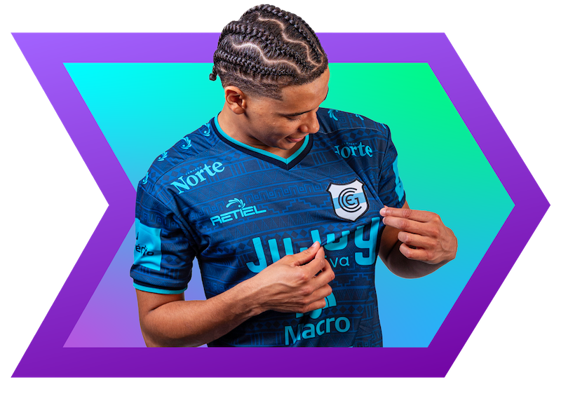 Person wearing a blue sports jersey with various brand logos on a colorful geometric background